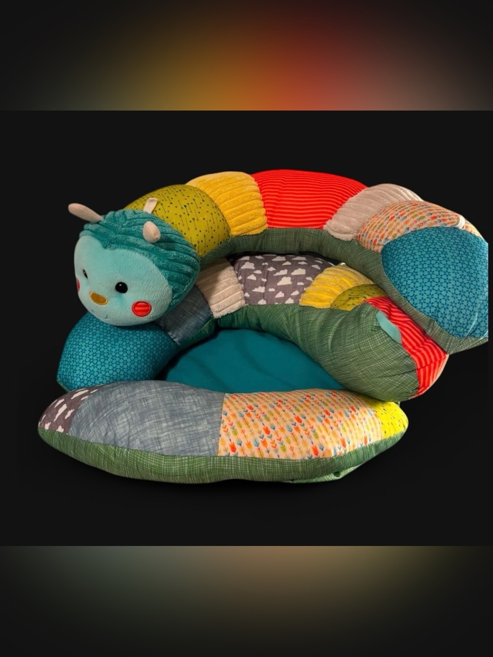 2-in-1 support pillow that extends flat for tummy time. Patchwork Caterpillar